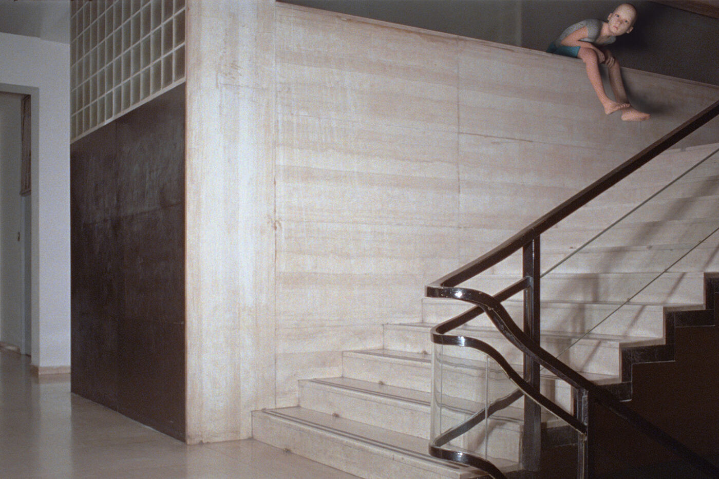 Still from Monelle by Diego Marcon: a CGI child sitting on the edge of a wall above a marble staircase